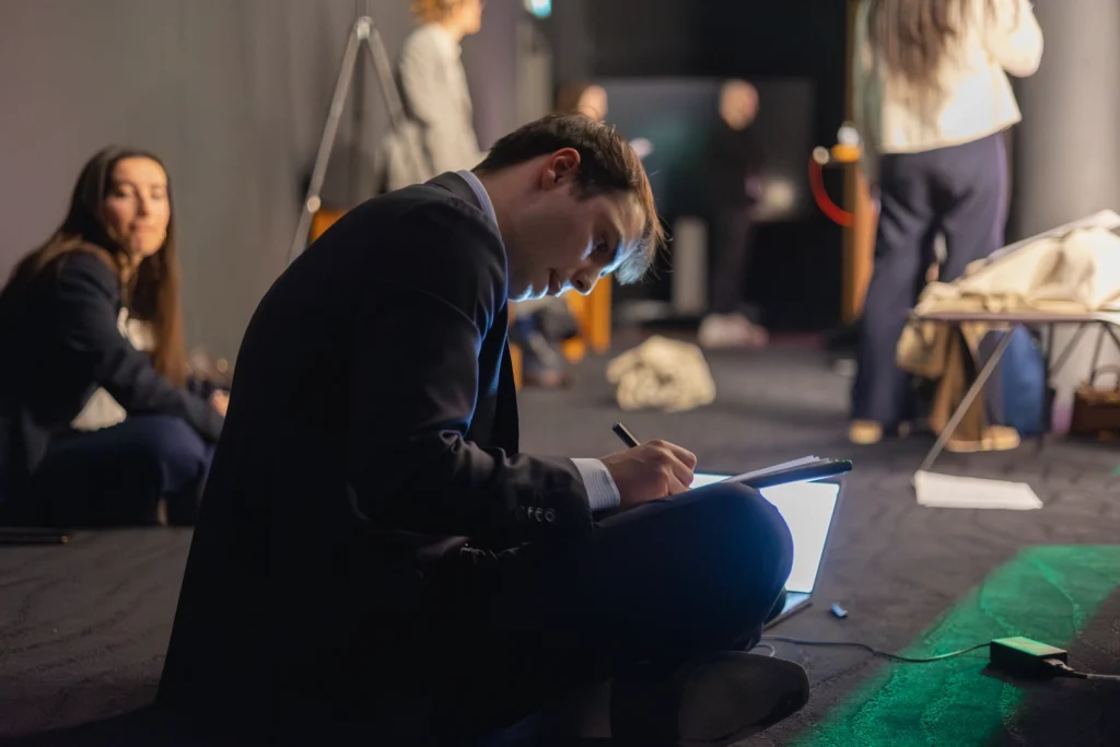 A smiling woman wearing a suit.